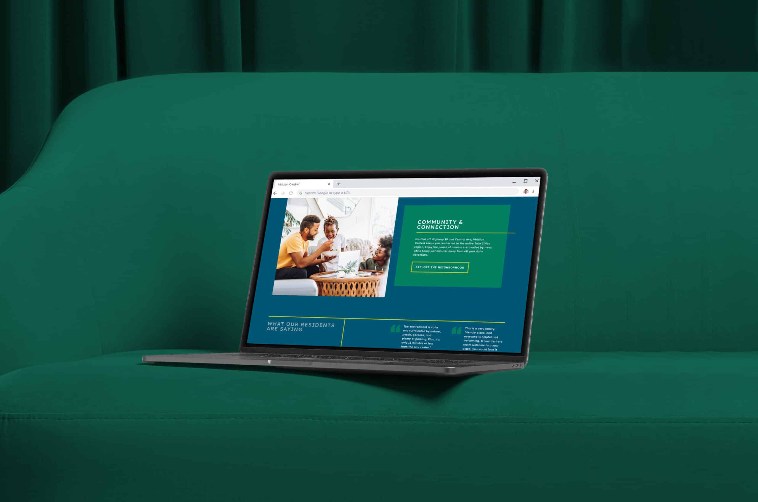 A laptop displaying a website sits on a green couch. The screen shows a section about community and connection with an image of two people and some text.