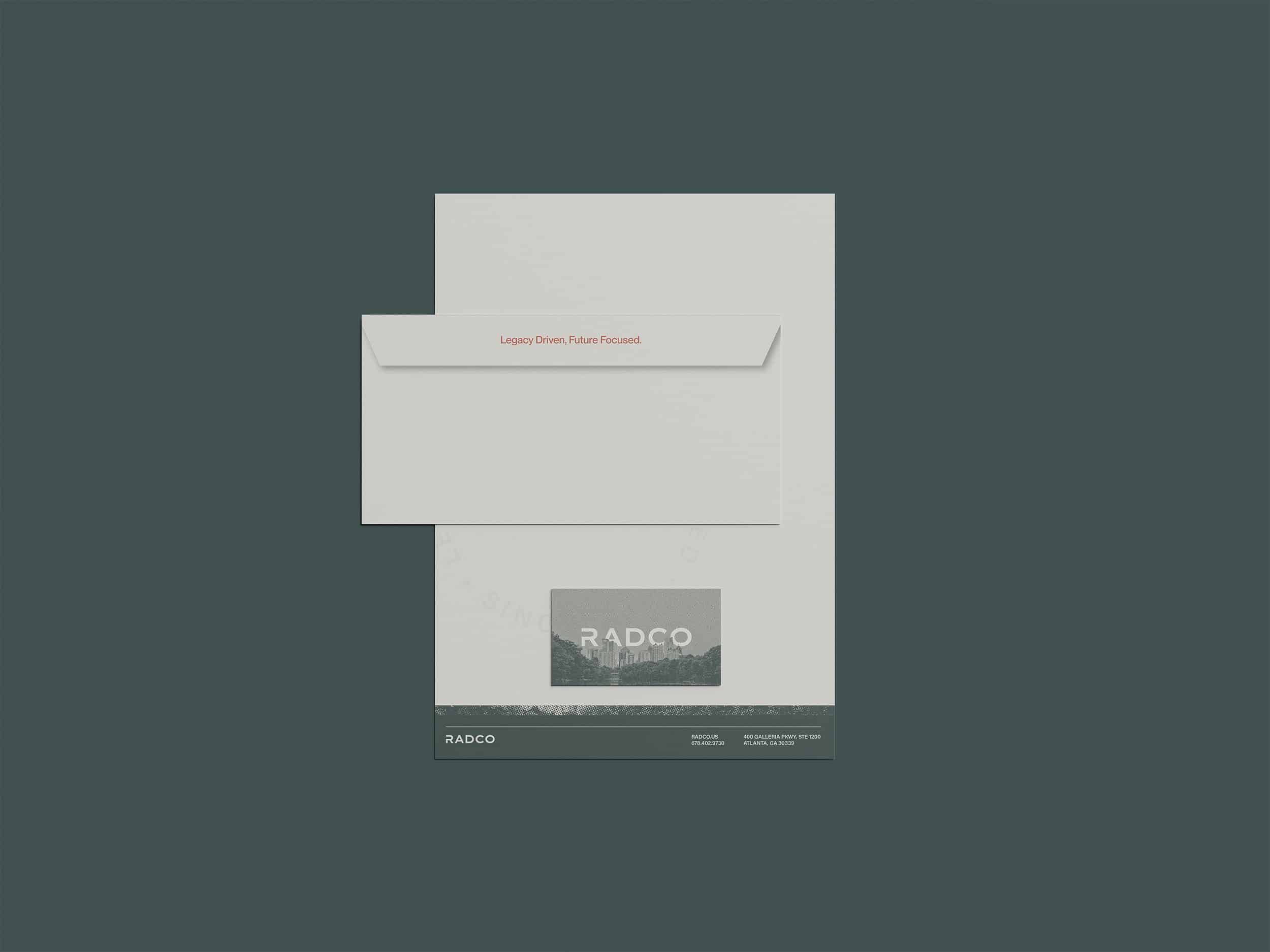 A dark green background with a white envelope and letterhead placed on it. The envelope has red text and the letterhead has a logo with the text "RADCO" at the bottom.